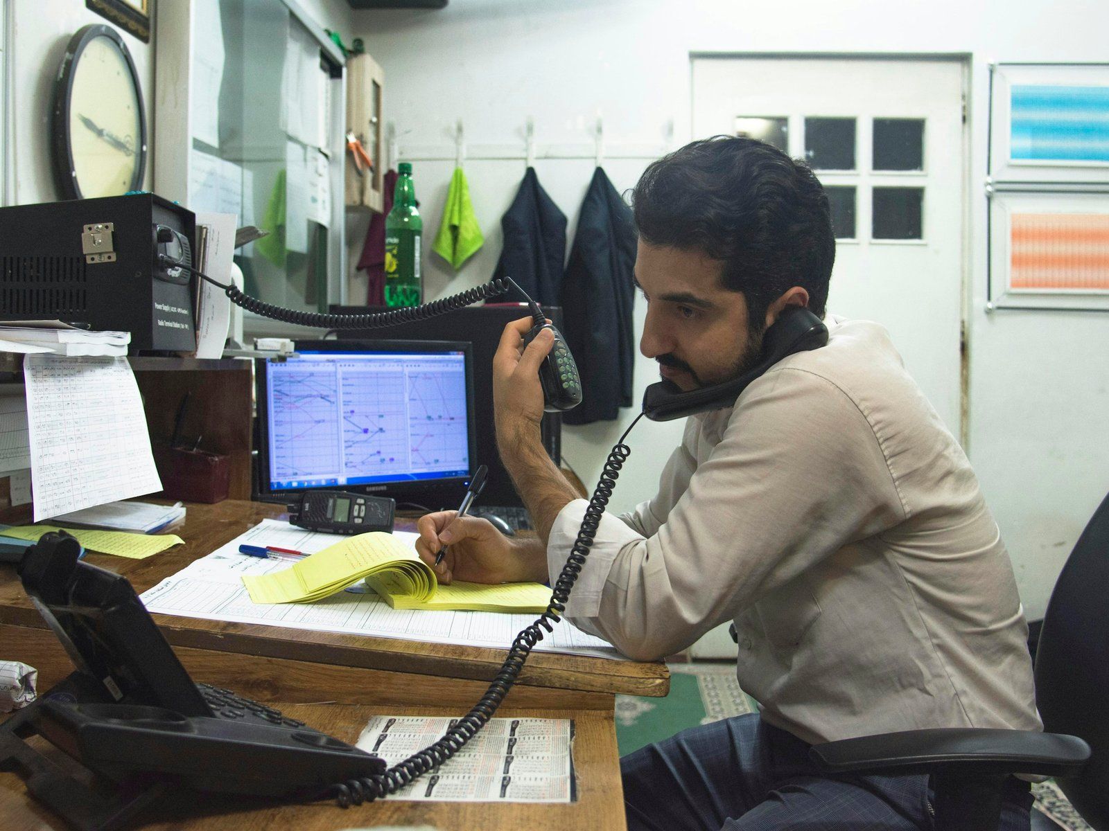 Manager talking on the phone at a desk