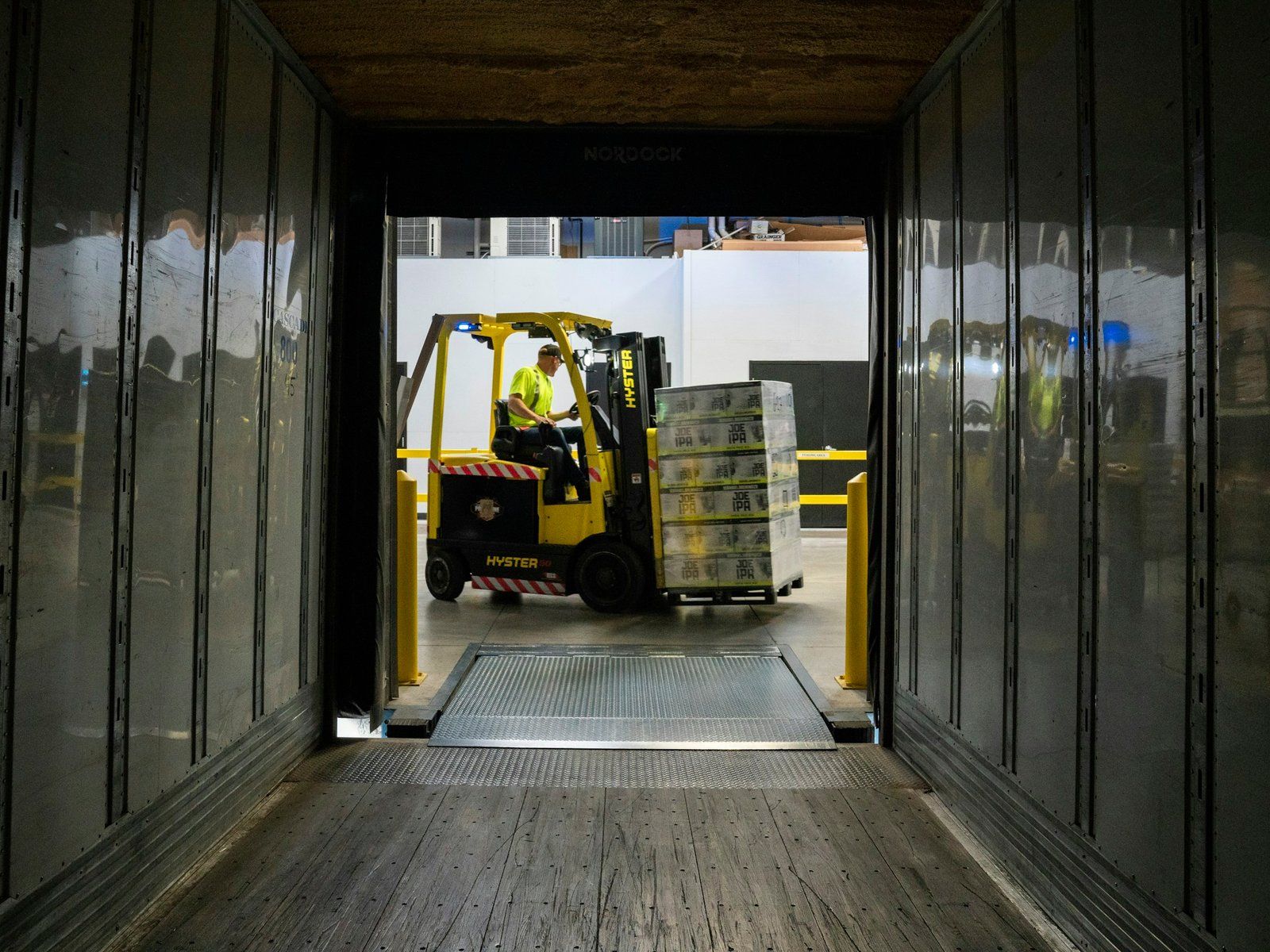 Forklift inside a truck body at a warehouse